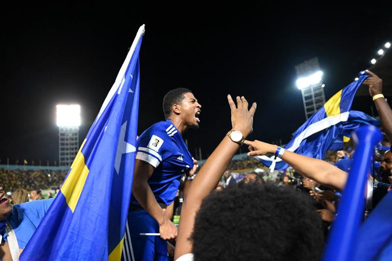 Cura&Atilde;&sect;ao players and fans celebrate World Cup 2026 qualification after a 0-0 draw with Jamaica at the National Stadium in Kingston, Jamaica on November 18, 2025. The tiny Caribbean nation of Curacao became the smallest country ever to qualify for the World Cup on November 18 as Haiti booked their return to the tournament for the first time in 52 years along with Panama.
A nerve-shredding finale to the CONCACAF qualifying campaign saw Curacao -- with a population of just 156,000 -- squeeze into next year's finals in the United States, Canada and Mexico with a 0-0 draw against Jamaica in Kingston. (Photo by Ricardo MAKYN / AFP) (Photo by RICARDO MAKYN/AFP via Getty Images)          