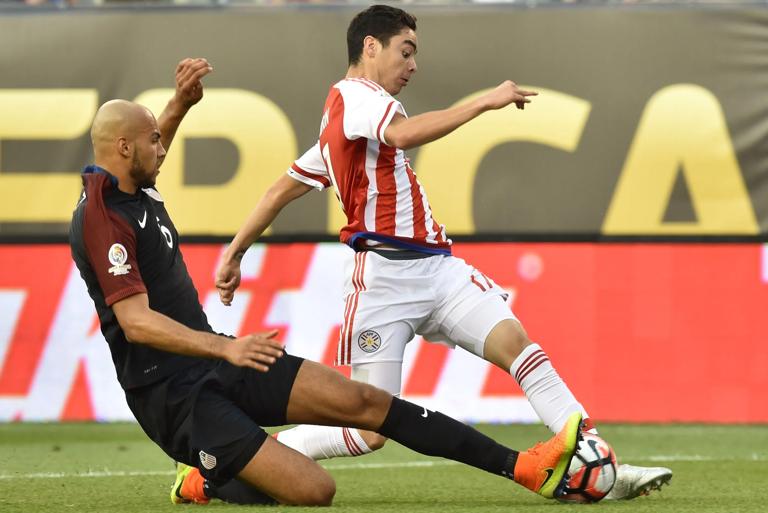 Paraguay's Miguel Angel Almiron (R) is marked by USA's John Brooks during their Copa America Centenario football tournament match in Philadelphia, Pennsylvania, United States, on June 11, 2016.  / AFP / NICHOLAS KAMM        (Photo credit should read NICHOLAS KAMM/AFP via Getty Images)