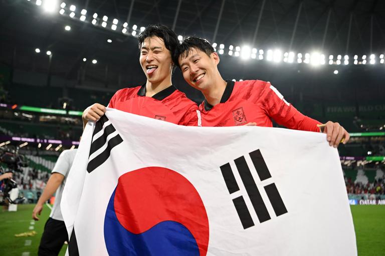AL RAYYAN, QATAR - DECEMBER 02: Heungmin Son (R) of Korea Republic celebrates after the 2-1 win during the FIFA World Cup Qatar 2022 Group H match between Korea Republic and Portugal at Education City Stadium on December 02, 2022 in Al Rayyan, Qatar. (Photo by Shaun Botterill - FIFA/FIFA via Getty Images)