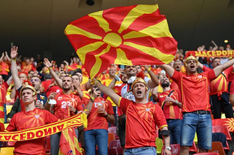 TOPSHOT - North Macedonia fans cheer for their team before the UEFA EURO 2020 Group C football match between Austria and North Macedonia at the National Arena in Bucharest on June 13, 2021. (Photo by Justin Setterfield / POOL / AFP) (Photo by JUSTIN SETTERFIELD/POOL/AFP via Getty Images)